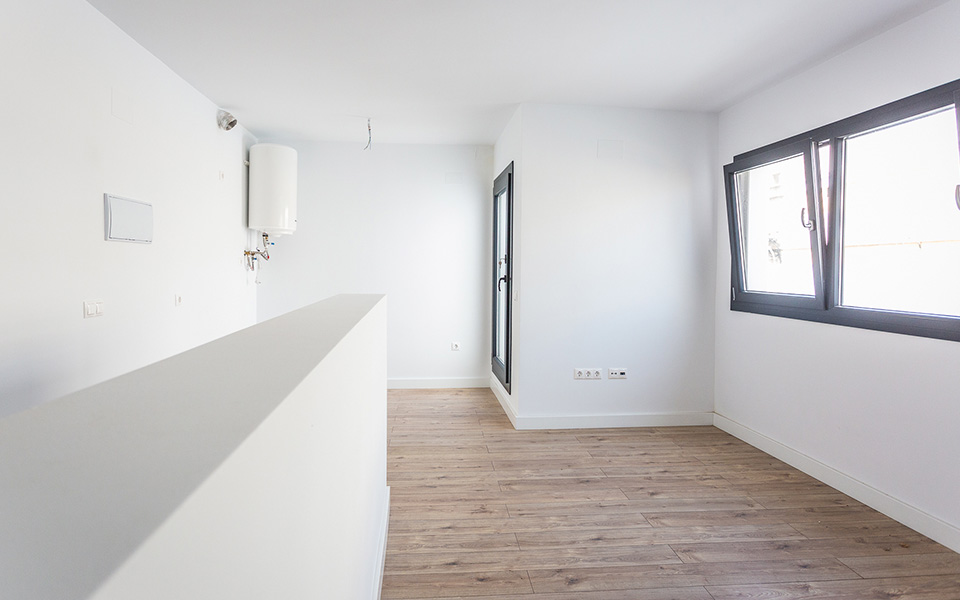 Windows in room with white walls and wooden floor