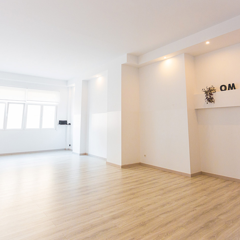 White room with bay window and soft brown wooden flooring
