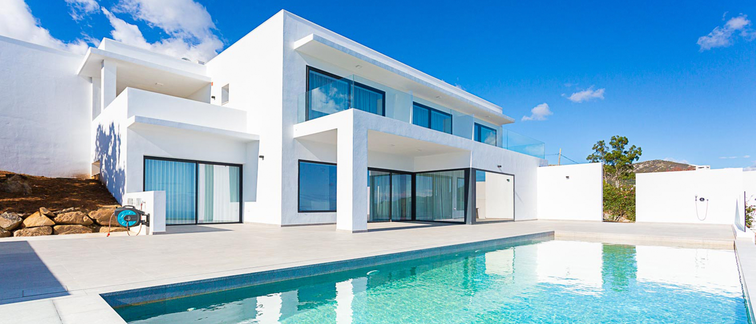 Mediterranean-style white detached house with windows and pool