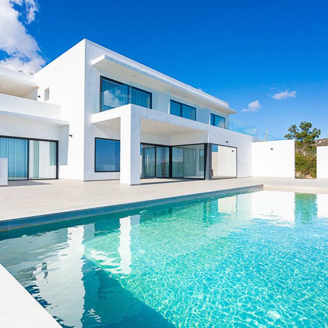 Mediterranean-style white detached house with windows and pool